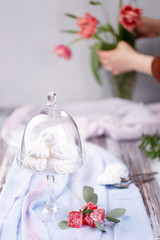 marshmallows in a glass stand on a blue fabric