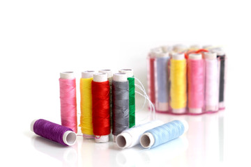 Small multicolor sewing threads row for quick repair clothes with blur background