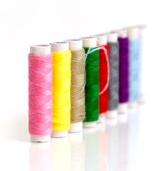 Row of Small multicolor sewing threads for quick repair clothes, Selective Focus image