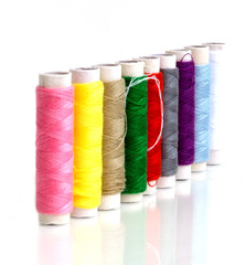 Row of Small multicolor sewing threads for quick repair clothes, Selective Focus image