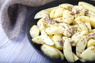 Crude potato with caraway  in a frying pan