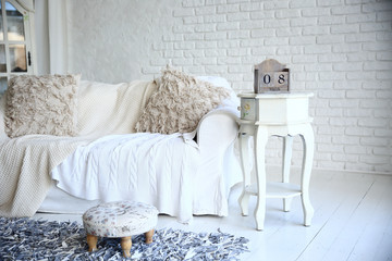 white sofa and nightstand with changeover calendar in a stylish living room