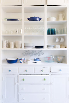 Interior of kitchen cabinet with dishes and glasses
