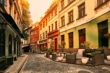 Fototapeta na wymiar Old medieval morning narrow street in Riga, Latvia. Retro styled.