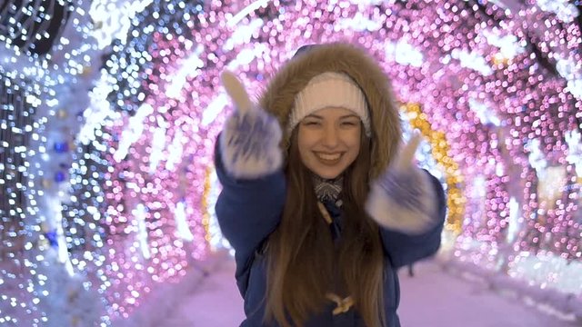 Slow motion. A young girl shows that she is doing well She smiles and rejoices.