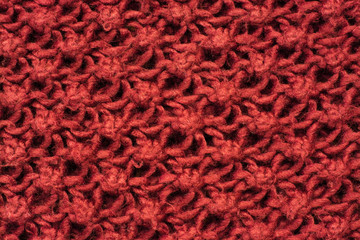 Knitted burgundy pattern close up background