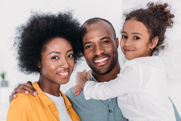 smiling african american family looking at camera