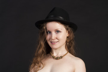 Portrait of a young woman in a hat and gloves.