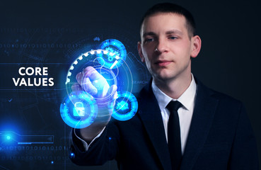 Business, Technology, Internet and network concept. Young businessman working on a virtual screen of the future and sees the inscription: Core values