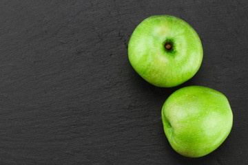 Green apples  on stone table. Top view with copy space