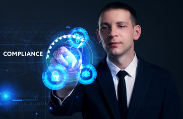Business, Technology, Internet and network concept. Young businessman working on a virtual screen of the future and sees the inscription: Compliance