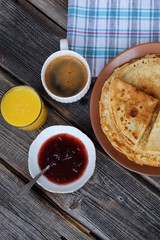 Fresh pancakes with strawberry jam, coffee and juice  