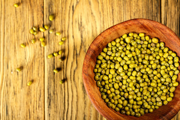 Mung, a family of beans, in a wooden plate in the village. Place for Your text.