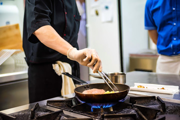 Chef preparing food on stove