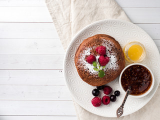 Chocolate pancakes with powdered sugar raspberry. Copy space