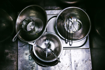 Stainless steel dishes in sink top view