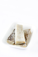 Salted dried cod isolated on white background. Typical Easter food