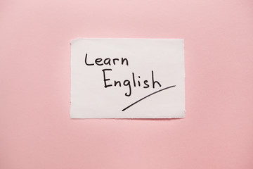 Learn English - words on real paper on pink background, studying language