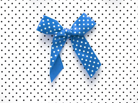 blue bow on  white dots background