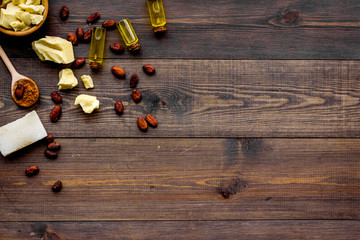 Homemade soap with cocoa butter. Cosmetics with natural ingredient. Dark wooden background top view space for text