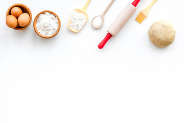 Roll out the dough. Dough ball near roller pin and other cookware on white background top view copy space