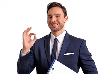 Handsome bearded businessman in office suit and tie isolated on white background. Professional bank manager is holding a blank clipboard