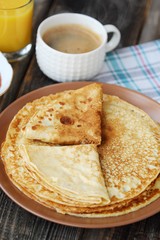 Fresh pancakes with strawberry jam, coffee and juice 