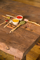 Various colorful herbs and spices on wooden table