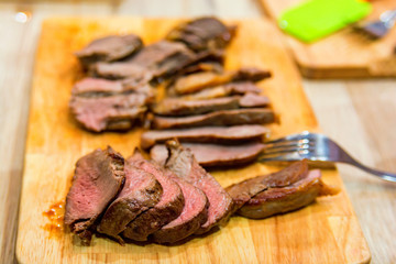 Close up sliced steak on cutting board