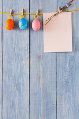 Colorful easter card and garland on wood background