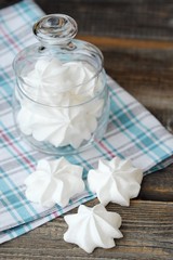 White fresh meringues in a glass jar   