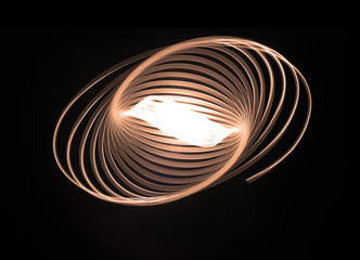 Spirographic, abstract, light patterns on a black background created with L.E.D. lighting that looks like lasers lights