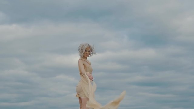 a young woman who looks like a character from a fairy tale turns back while walking through a deserted place, a woman with gray hair looks mysteriously and mysteriously