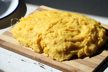 fresh boiled polenta on a wooden plateau