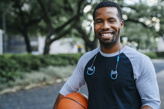 Portrait of smiling man holding basketball