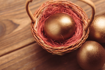 gold eggs on wooden table