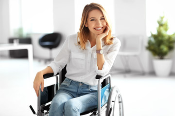 Young woman in wheelchair at workplace