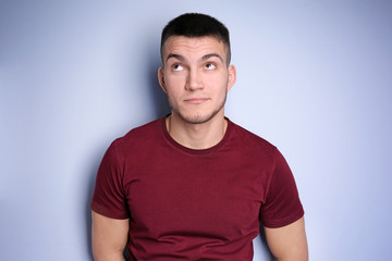 Obraz premium Emotional young man with dyed eyebrows on light background