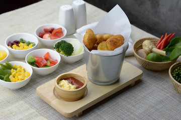 Fried Nuggets in a silver bucket on the table
