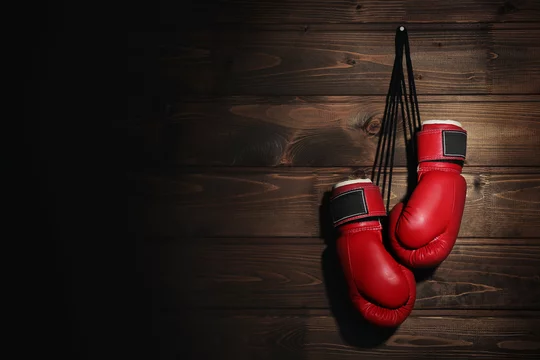 Boxing gloves on wooden background Photos | Adobe Stock