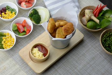 Fried Nuggets in a silver bucket on the table