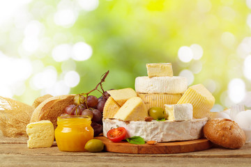 Variety of cheese types composition on wooden board