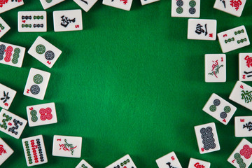 White-green tiles for mahjong on on green cloth background