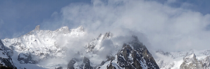 Panoramic beautiful Misty mountains with foggy sunshine blue sky in morning at Alpes in Italy