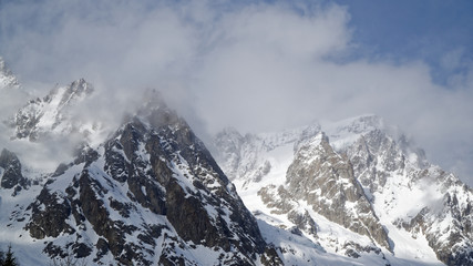 Obraz premium Granite mountains covered with snow and winter forest near Mont Blanc Alpes, Italy