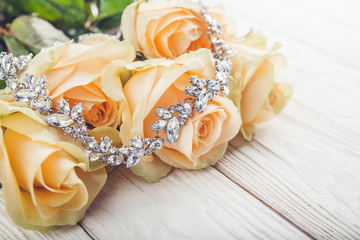 Beautiful diamond necklace on orange roses.