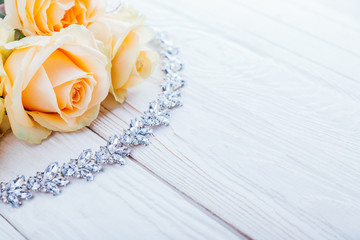 Beautiful diamond necklace by orange roses.