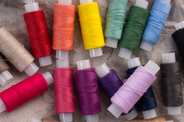 Colored thread on a linen background