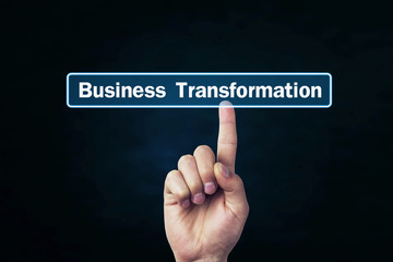 Man hand pressing on Business Transformation text on screen.