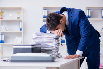 Businessman making copies in copying machine